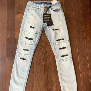 New jeans with holes light colored.